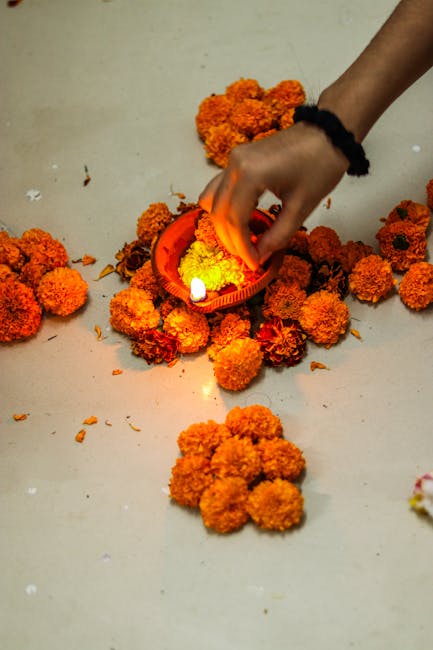 Marigold flowers and candle in a traditional Tihar festival ritual.